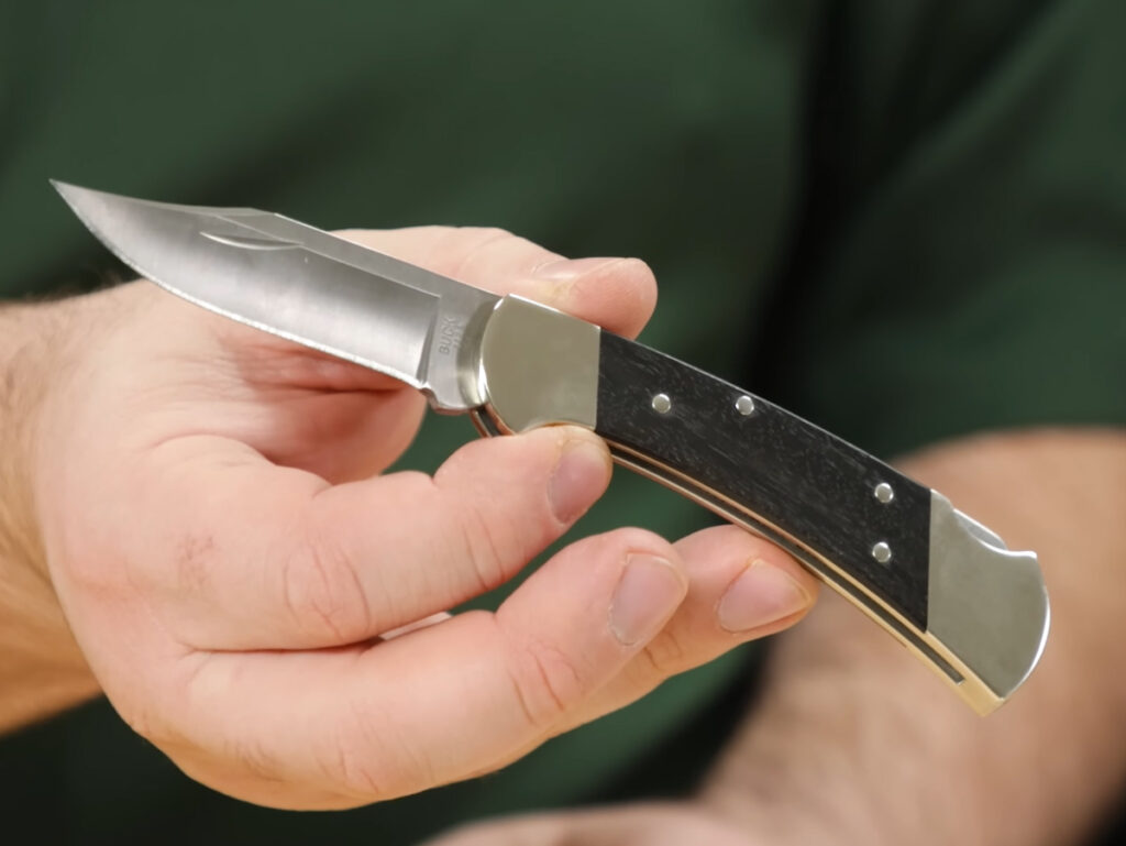 Buck 112 Slim Heritage Nickel Silver pocket knife held in hand